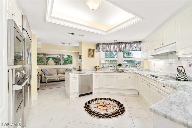 kitchen featuring stainless steel appliances, white cabinetry, light tile patterned floors, and custom range hood