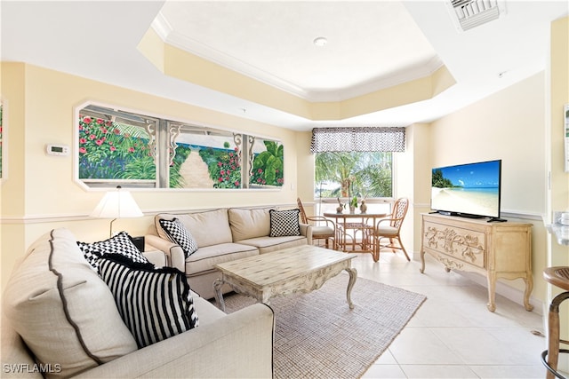 tiled living room with a tray ceiling and ornamental molding