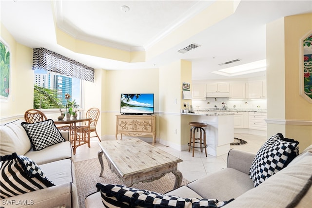 living room featuring a tray ceiling, light tile patterned floors, and crown molding