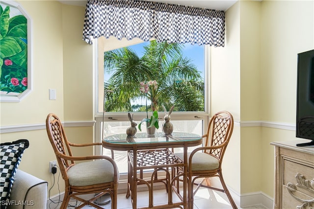 dining space with plenty of natural light and light tile patterned floors