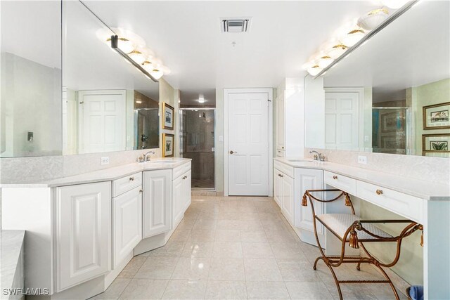 bathroom featuring walk in shower, vanity, and tile patterned floors