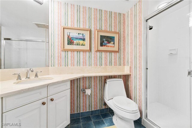 bathroom featuring vanity, tile patterned floors, an enclosed shower, and toilet