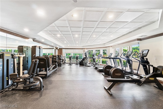 gym featuring coffered ceiling and plenty of natural light