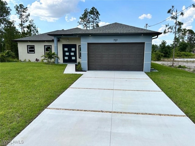 view of front facade with a front yard and a garage