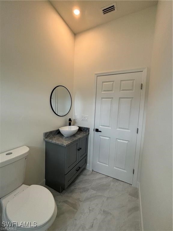 bathroom with vanity and toilet