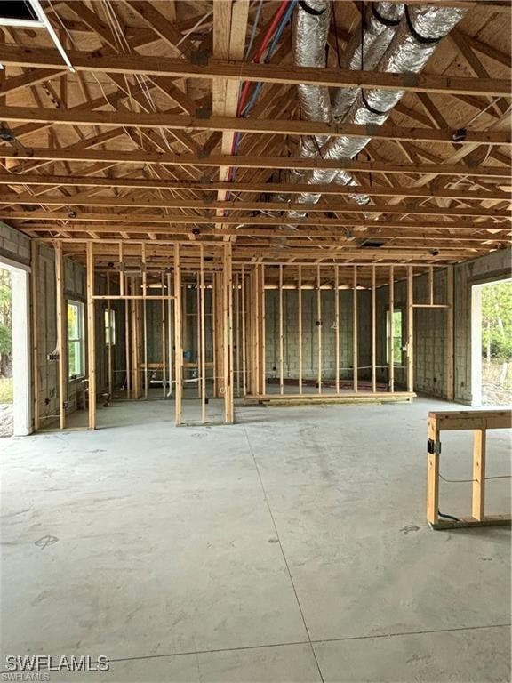 miscellaneous room featuring a wealth of natural light and lofted ceiling