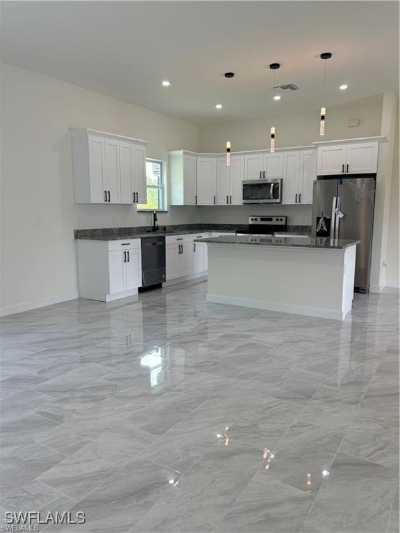 kitchen with white cabinetry, pendant lighting, stainless steel appliances, a center island, and sink