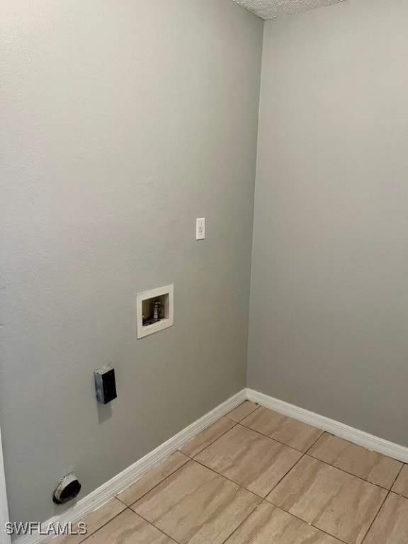 laundry room featuring hookup for a washing machine and light tile patterned flooring