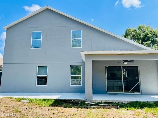 back of property featuring ceiling fan and a patio area