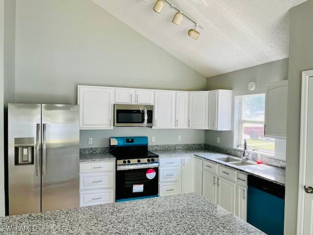 kitchen with a textured ceiling, stainless steel appliances, sink, and white cabinets