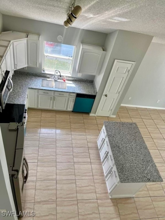 kitchen with light tile patterned floors, white cabinetry, appliances with stainless steel finishes, and sink