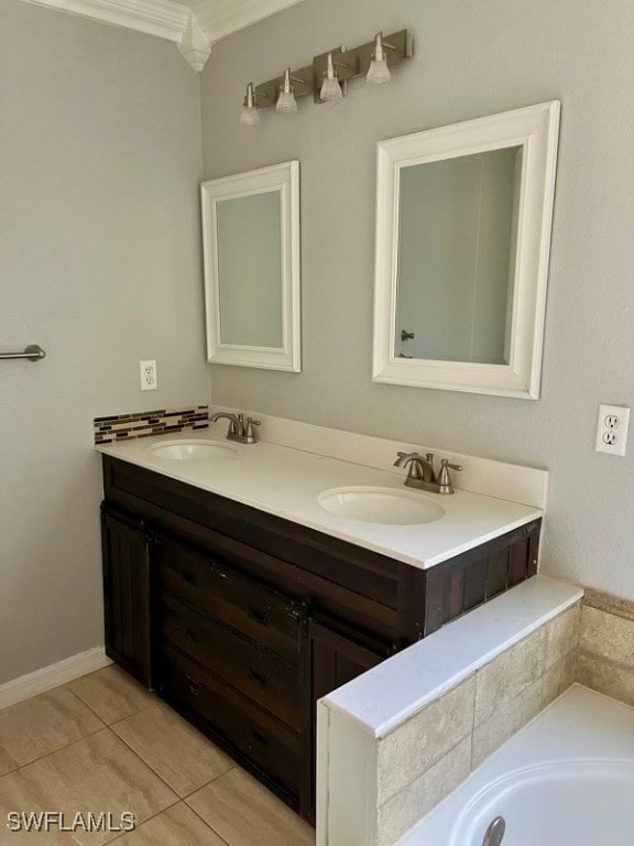 bathroom featuring tile patterned flooring, vanity, and crown molding