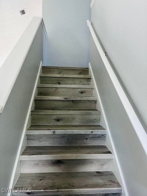 stairs with hardwood / wood-style flooring