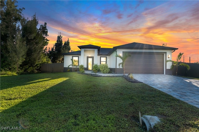 contemporary house with a garage and a lawn