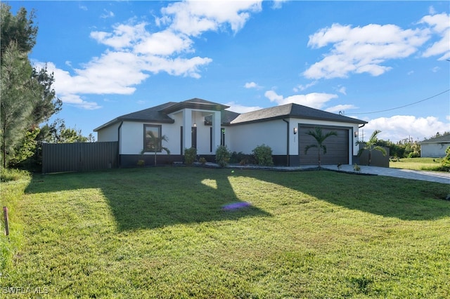 view of front of home with a garage and a front lawn