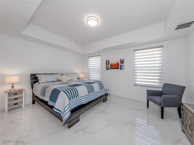 bedroom with a raised ceiling