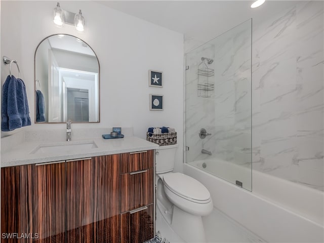 full bathroom with toilet, tiled shower / bath combo, and vanity