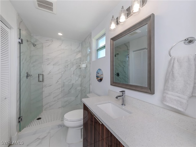 bathroom featuring vanity, toilet, and a shower with shower door