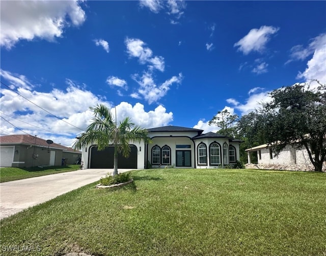 view of front of home featuring a front yard and a garage