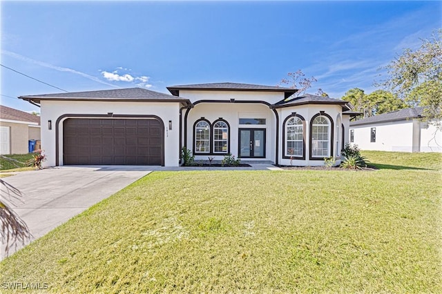 view of front of home featuring french doors, a front yard, and a garage