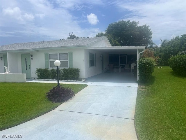52 Heath Aster Ln, Lehigh Acres, FL 33936 - view of front facade with concrete driveway, a front yard, an attached carport, stucco siding, and a shingled roof