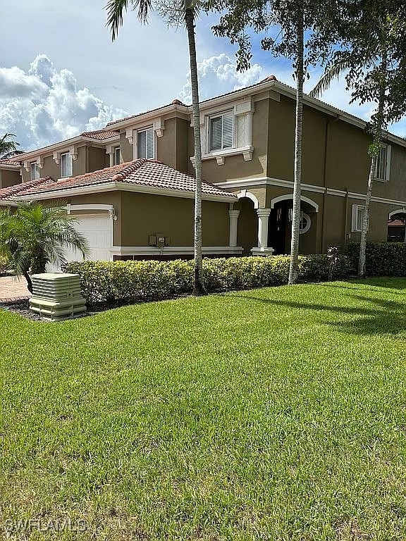 view of front facade with a front lawn and a garage