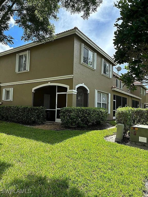 back of house with a lawn