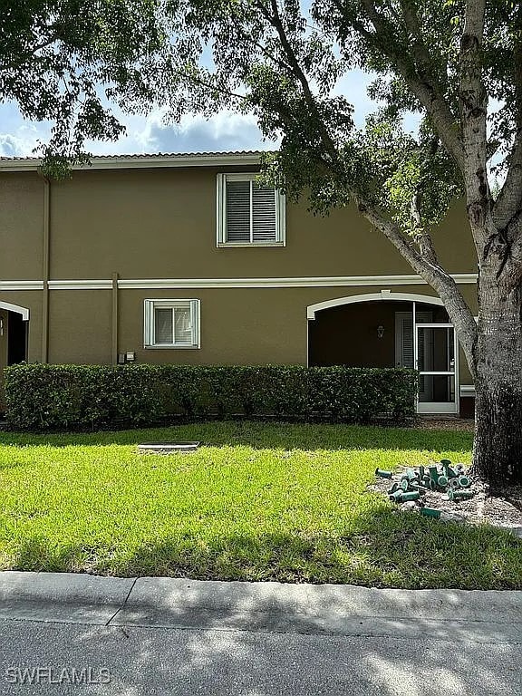 view of side of home with a yard