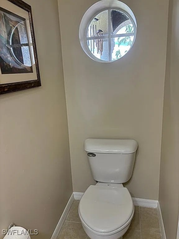 bathroom featuring toilet and tile patterned floors