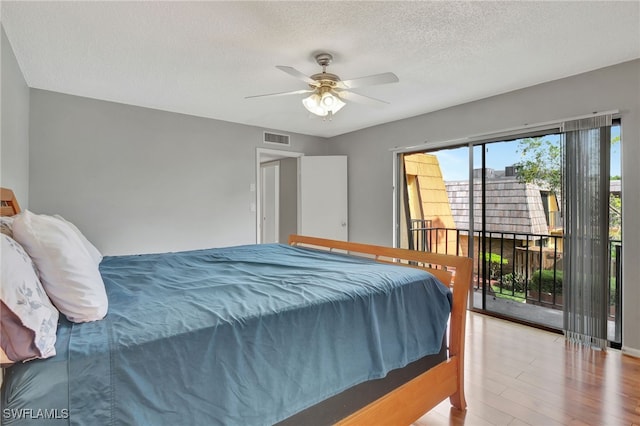 bedroom with a textured ceiling, ceiling fan, access to outside, and light hardwood / wood-style floors