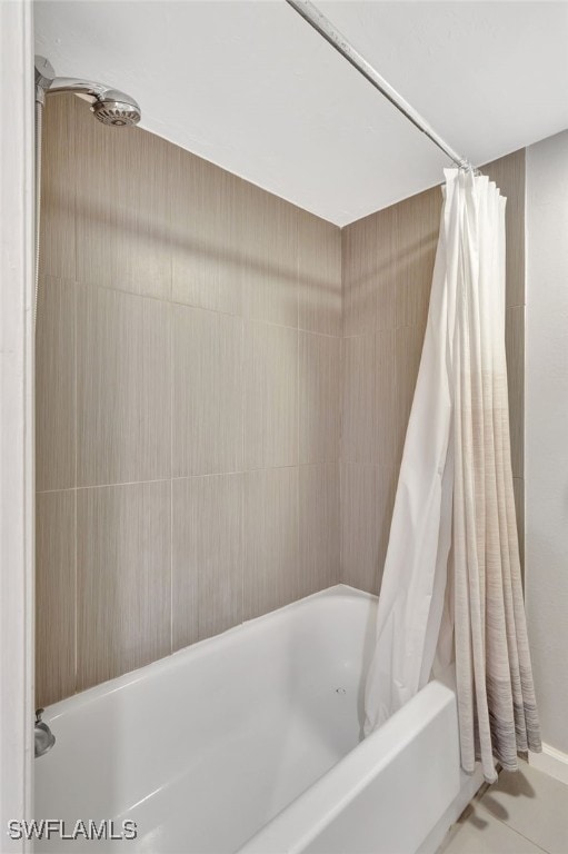 bathroom featuring shower / tub combo with curtain and tile patterned flooring