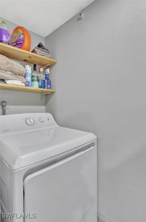 clothes washing area with washer / dryer