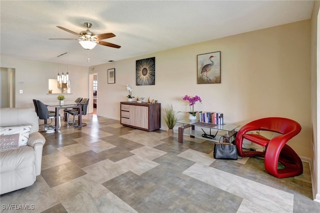 living room with a textured ceiling and ceiling fan