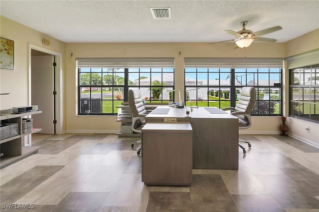 home office featuring a textured ceiling and ceiling fan