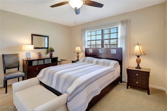 bedroom with ceiling fan and light colored carpet