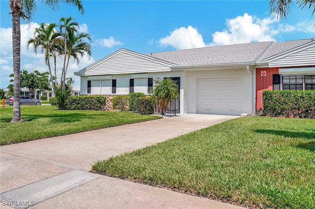 single story home featuring a garage and a front yard