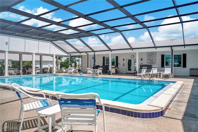 view of pool featuring french doors, glass enclosure, and a patio