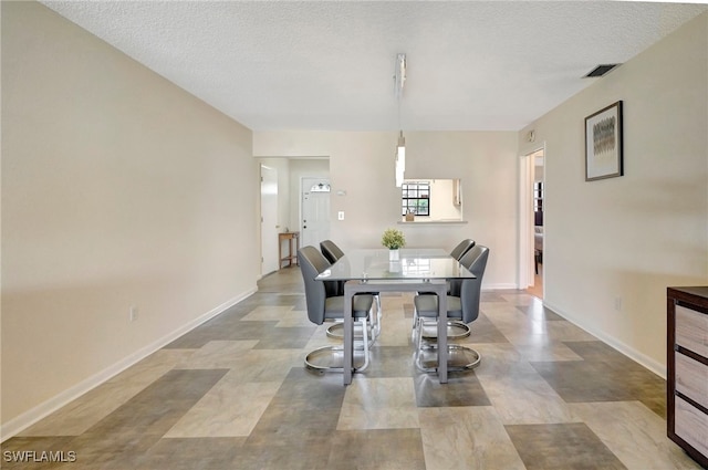 dining area with a textured ceiling