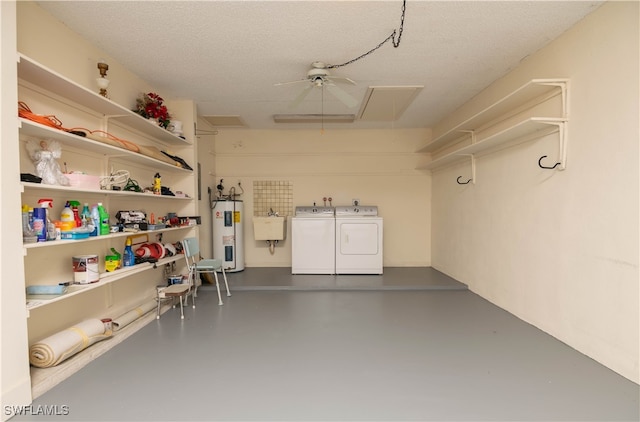 garage with washer and clothes dryer, sink, ceiling fan, and water heater