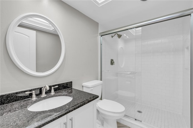 bathroom with tile patterned flooring, a shower with door, toilet, and vanity