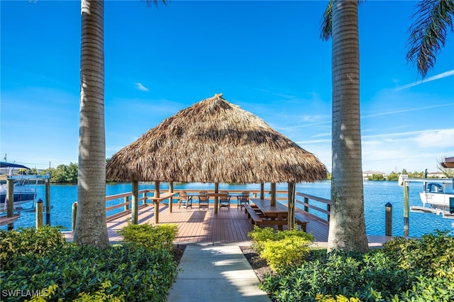 exterior space with a boat dock, a water view, and a gazebo