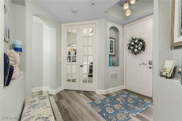 entryway featuring light hardwood / wood-style floors and french doors