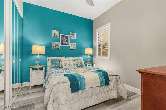 bedroom with light wood-type flooring and ceiling fan