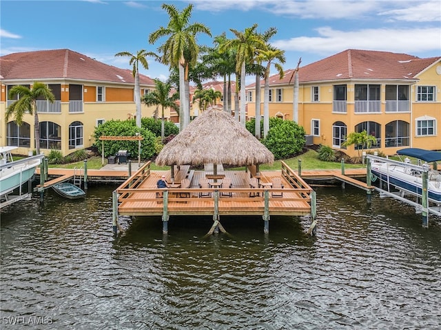 dock area featuring a balcony, a gazebo, and a water view