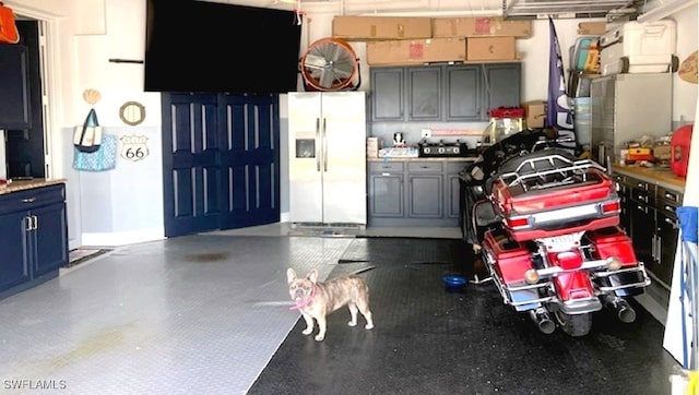 garage featuring refrigerator with ice dispenser