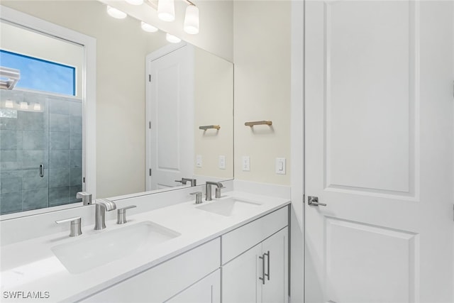 bathroom featuring vanity and an enclosed shower