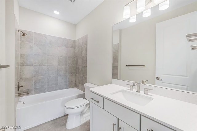 full bathroom with tile patterned floors, tiled shower / bath, toilet, and vanity