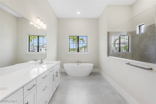 bathroom featuring tile patterned flooring, plenty of natural light, independent shower and bath, and vanity