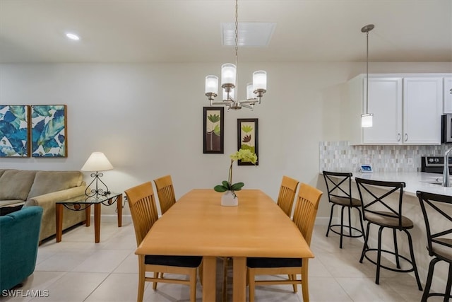 dining room with a notable chandelier and light tile patterned flooring