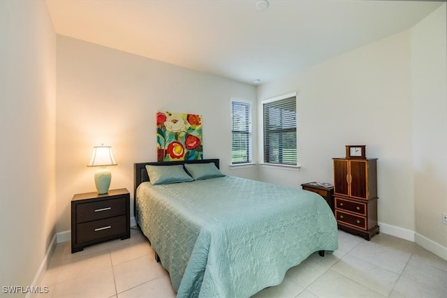 bedroom with light tile patterned floors